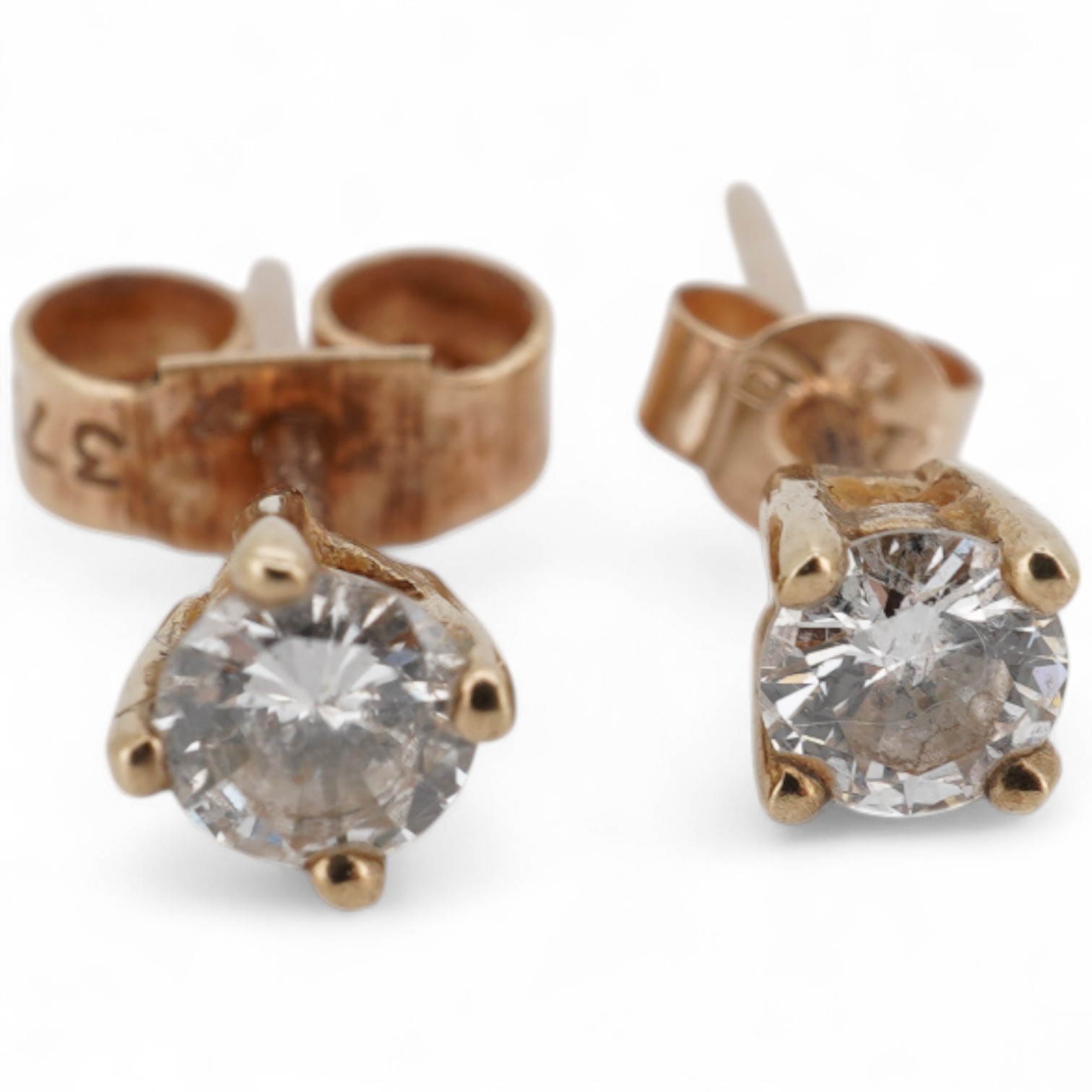 A pair of 9ct gold and solitaire diamond set ear studs, each stone weighing approximately 0.15ct.